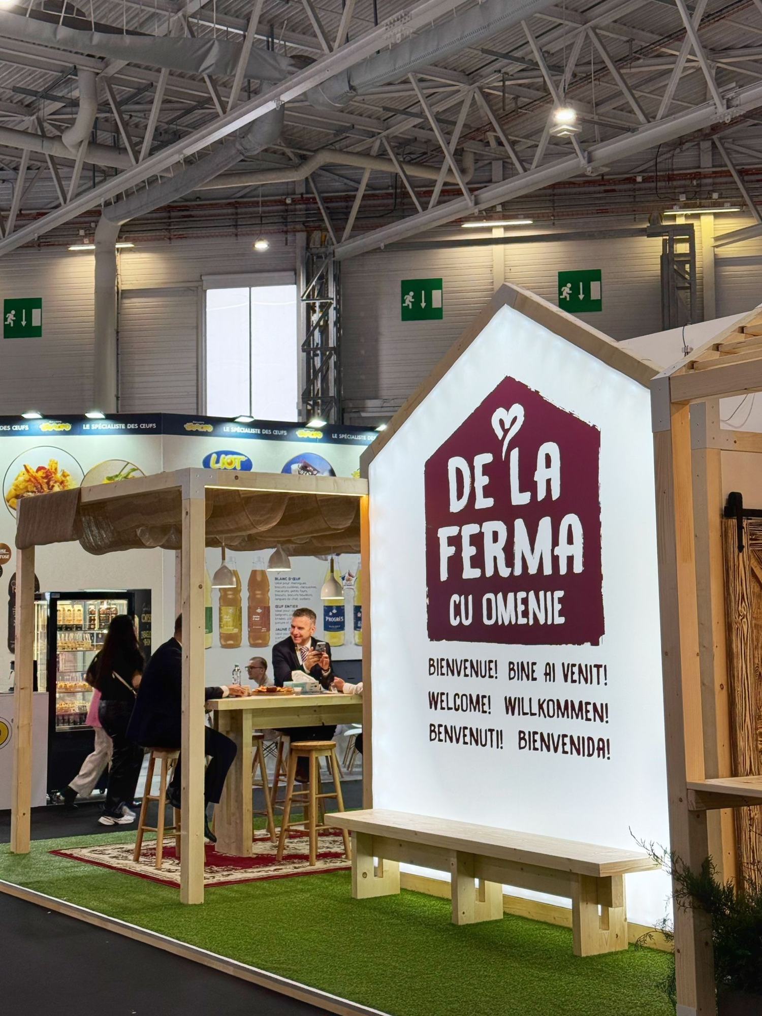 House-shaped light box with a welcome message in six languages